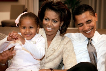 Photo of young Sasha Obama with her parents, Barack and Michelle Obama.