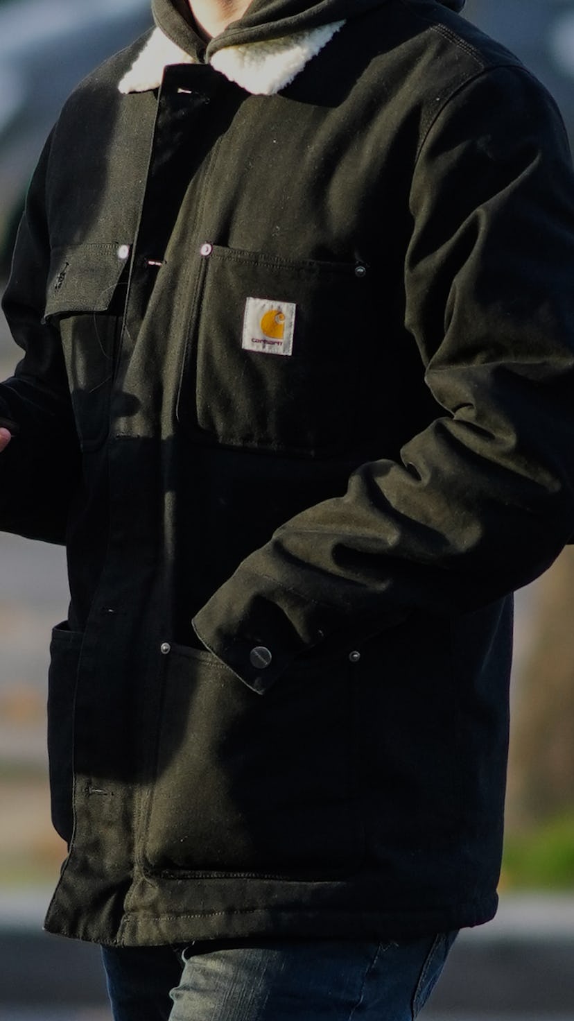 PARIS, FRANCE - NOVEMBER 18: A passerby wears a khaki hoodie sweater, a khaki with white sheep inter...