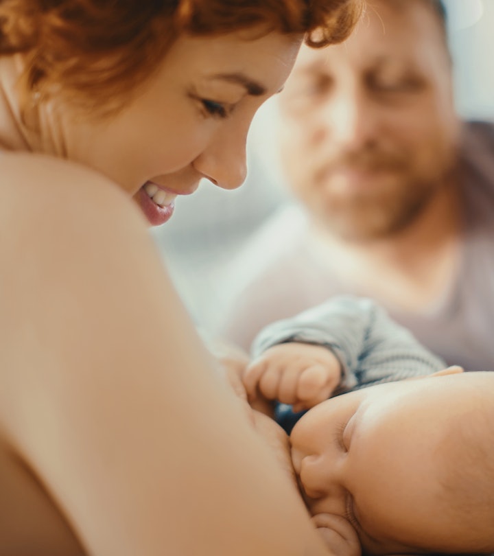 woman breastfeeding with partner in background, how can dads help with breastfeeding