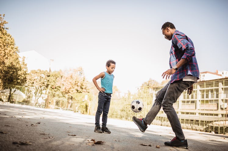 Father and son playing soccer