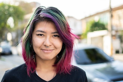Queer woman with dyed hair exploring gender identity and expression