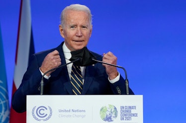 US President Joe Biden removes his facemask as he steps to the podium to present his national statem...