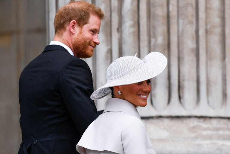 TOPSHOT - Britain's Prince Harry and his wife Meghan, the Duke and Duchess of Sussex, arrive to the ...