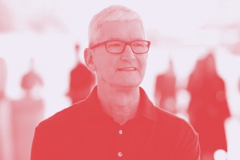 Apple CEO Tim Cook poses for a portrait next to a line of new MacBook Airs as he enters the Steve Jo...