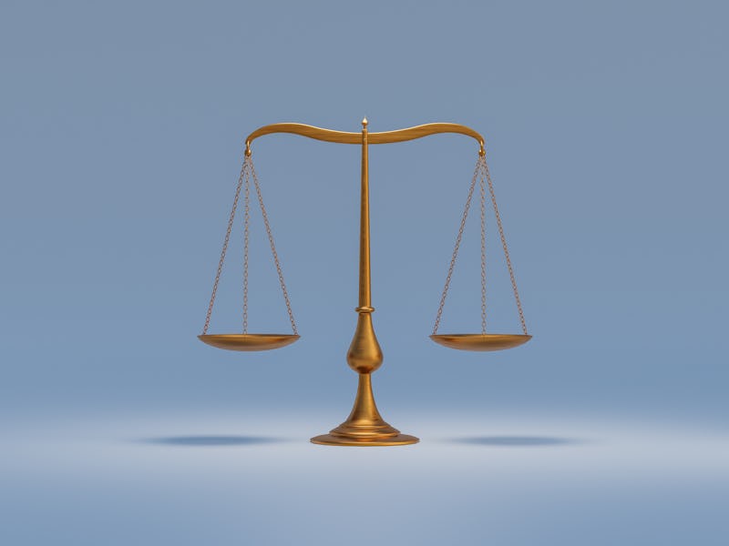 Old empty scales in brass colour against grey background. Historical weighing equipment as symbol of...