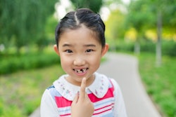 Little Girl Pointing at the Lost Tooth, is the tooth fairy real? how to talk to kids about the tooth...