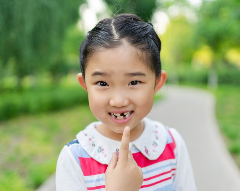 Little Girl Pointing at the Lost Tooth, is the tooth fairy real? how to talk to kids about the tooth...
