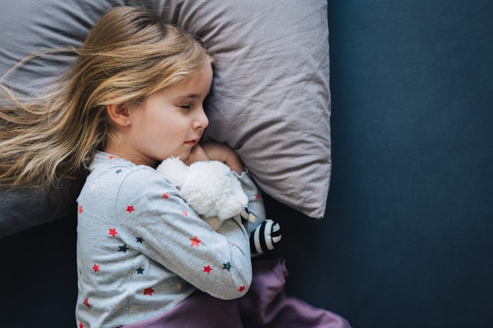 A child sleeping in bed alone.