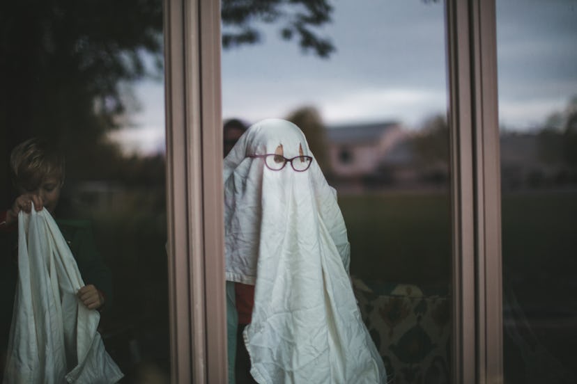 Child dresses up as a ghost wearing a white sheet, the haunted is a kid-friendly ghost story