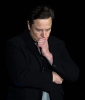 Elon Musk pauses and looks down as he speaks during a press conference at SpaceX's Starbase facility...
