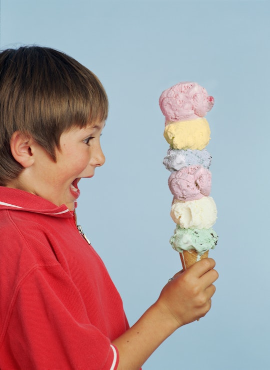 boy holding 6-scoop ice cream cone, best new ice cream flavors of summer 2022