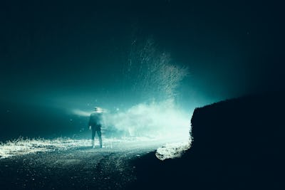 A horror, sci fi concept. Of a man vanishing into smoke in front of mysterious bright lights. On a s...