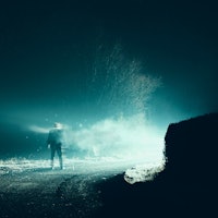 A horror, sci fi concept. Of a man vanishing into smoke in front of mysterious bright lights. On a s...
