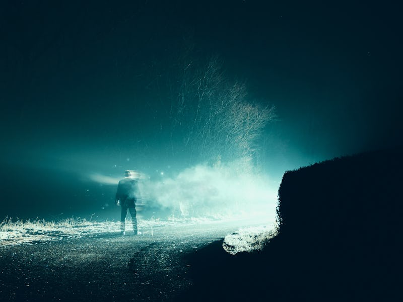 A horror, sci fi concept. Of a man vanishing into smoke in front of mysterious bright lights. On a s...