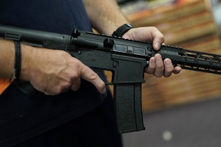 A customer handles an AR-15 at Jimmy's Sport Shop  in Mineola, New York. U.S. politicians are grappl...