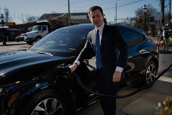 Takoma Park, MD - December 14: Transportation Secretary Pete Buttigieg, plugs the electric car in th...