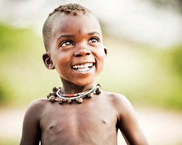A curious young African child of the Hadzabe tribe (Africa's last hunter/gatherer tribe) in Tanzania...