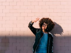 Young woman smiles big as she blocks the sun from her face and gears up for her June 20, 2022 weekly...