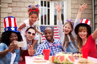 Smiling friends having fun at their back yard on4th July. . They making selfie