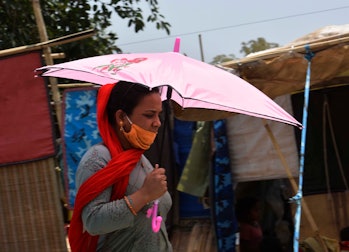 GURUGRAM, INDIA  APRIL 28: A woman walks under the shade of her umbrella in the midst of an ongoing ...