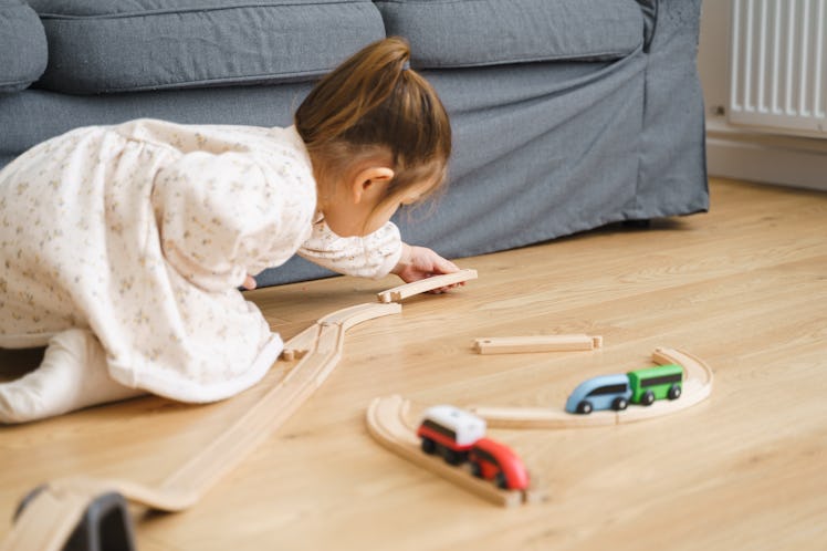Child playing with toy trains.