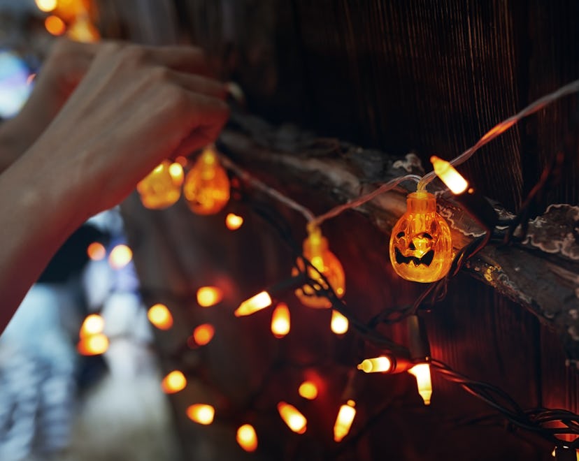 halloween party prep with glowing pumpkin lights in a dark room in an article about costco halloween...
