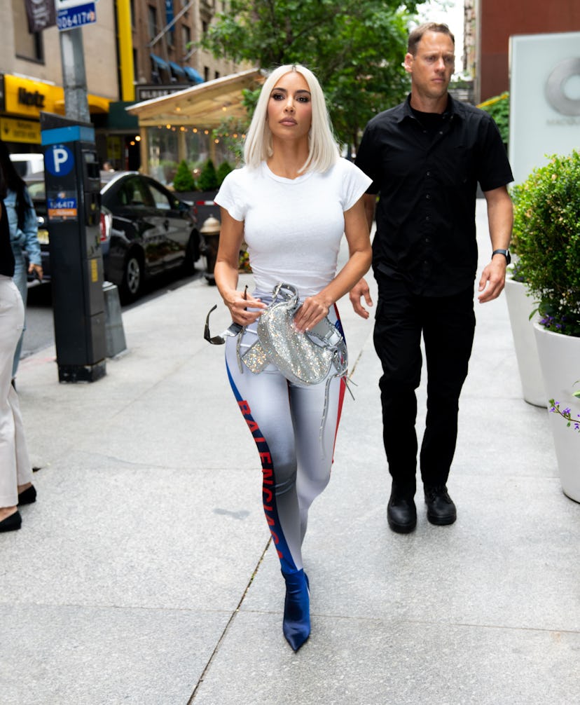 Kim Kardashian is seen wearing red and blue balenciaga pantaboots 