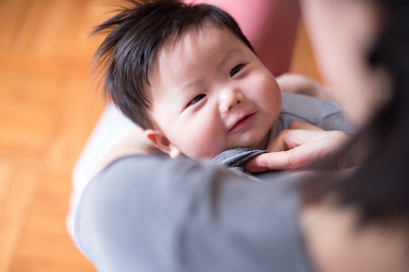 baby looking at mother in an article about baby names that start with "M"