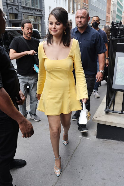 selena gomez wears yellow mini dress with clear high heels