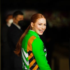 PARIS, FRANCE - JANUARY 24: Madelaine Petsch wears gold earrings, a white shirt, a neon green with b...