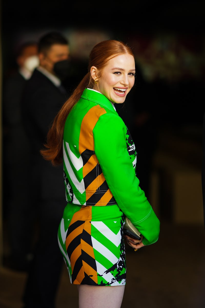 PARIS, FRANCE - JANUARY 24: Madelaine Petsch wears gold earrings, a white shirt, a neon green with b...