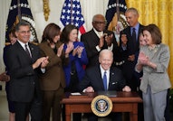 US President Joe Biden (C) prepares to sign an executive order intended to strengthen the Affordable...