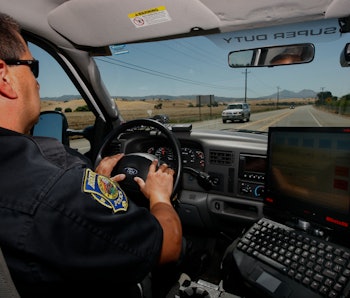 Police officer George Aquirre cruises down a rural road while on patrol in Brentwood, Calif., on Wed...