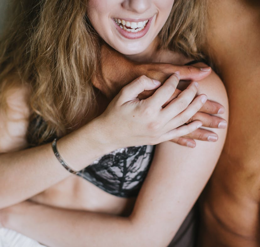 A couple hugging while in bed