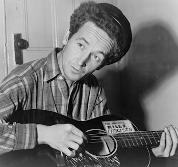 Portrait photograph of Woody Guthrie (Woodrow Wilson Guthrie) (1912-1967) American singer-songwriter...