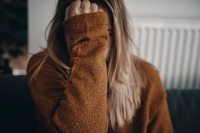 Frustrated woman holding her hand in front of her face