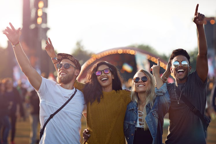 Friends hanging out at big music festival use concert Instagram captions for their summer festival.
