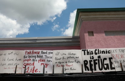 Signs by abortion rights activists sit on a fence outside of the Jackson Women's Health Organization...