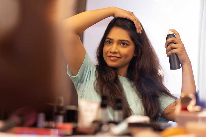 woman using hairspray