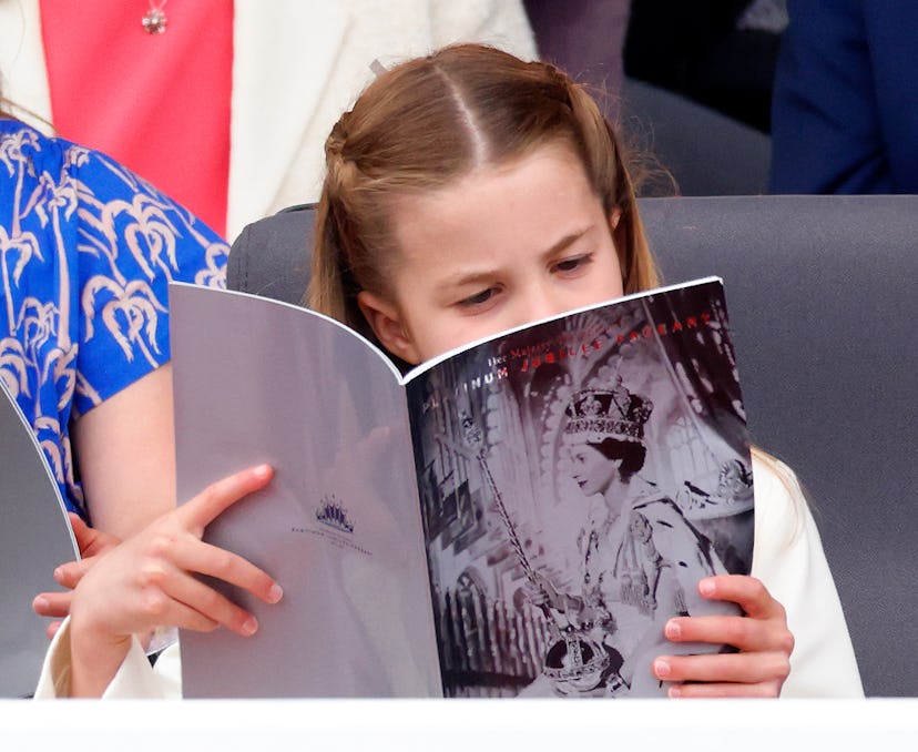 Princess Charlotte reads up on Queen Elizabeth.