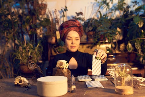 Female fortune teller in turban reading oracle cards. These are the best oracle card decks for begin...