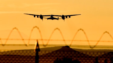 TOPSHOT - Virgin Galactic's SpaceshipTwo takes off for a suborbital test flight on December 13, 2018...