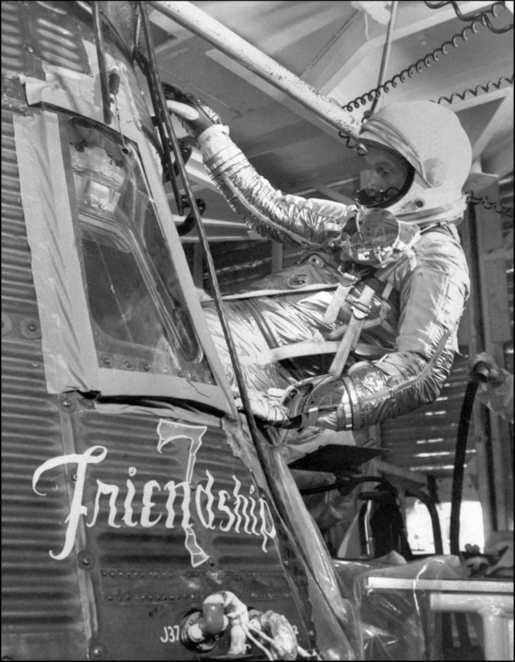 US astronaut John Glenn gets into the Mercury capsule Friendship 7 during a training session for his...