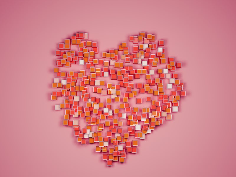 Abstract heart shape form by group of red and orange cubes on red background still life