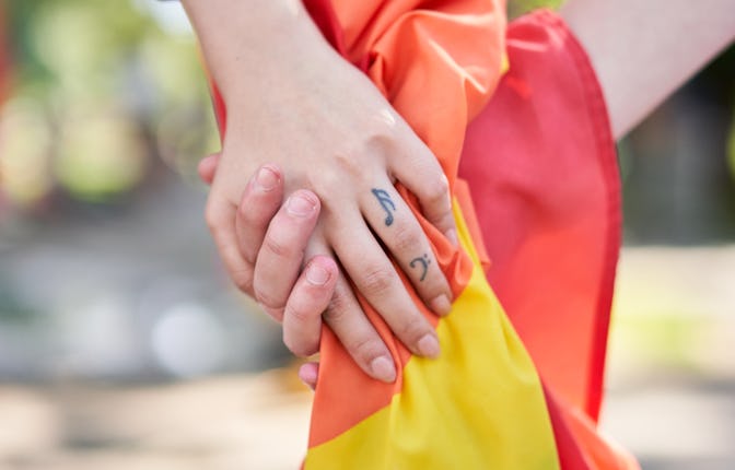 Happy lesbian couple wearing rainbow bracelet