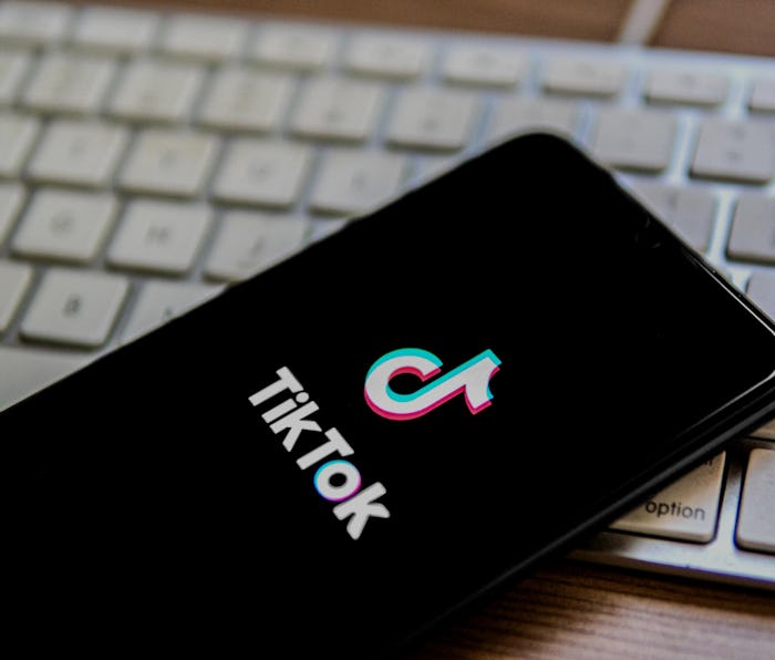 SPAIN - 2022/04/25: In this photo illustration, a TikTok logo seen displayed on a smartphone placed ...