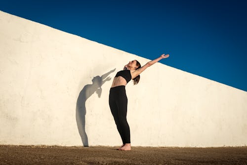 A woman stretches. Here’s your July 19 zodiac sign daily horoscope.