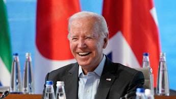 US President Joe Biden smiles at the start of a lunch with Representatives of Seven rich nations (G7...