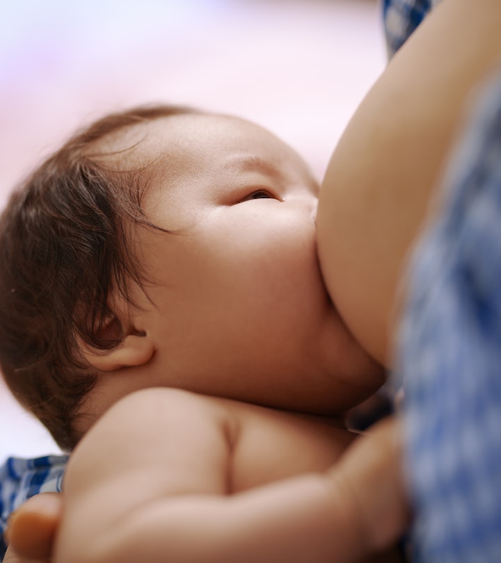 Mom breastfeeds her newborn baby in an article about if you can drink coffee while breastfeeding or ...