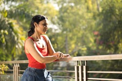 Young woman admiring view at balcony. Here's your july 20 zodiac sign daily horoscope 